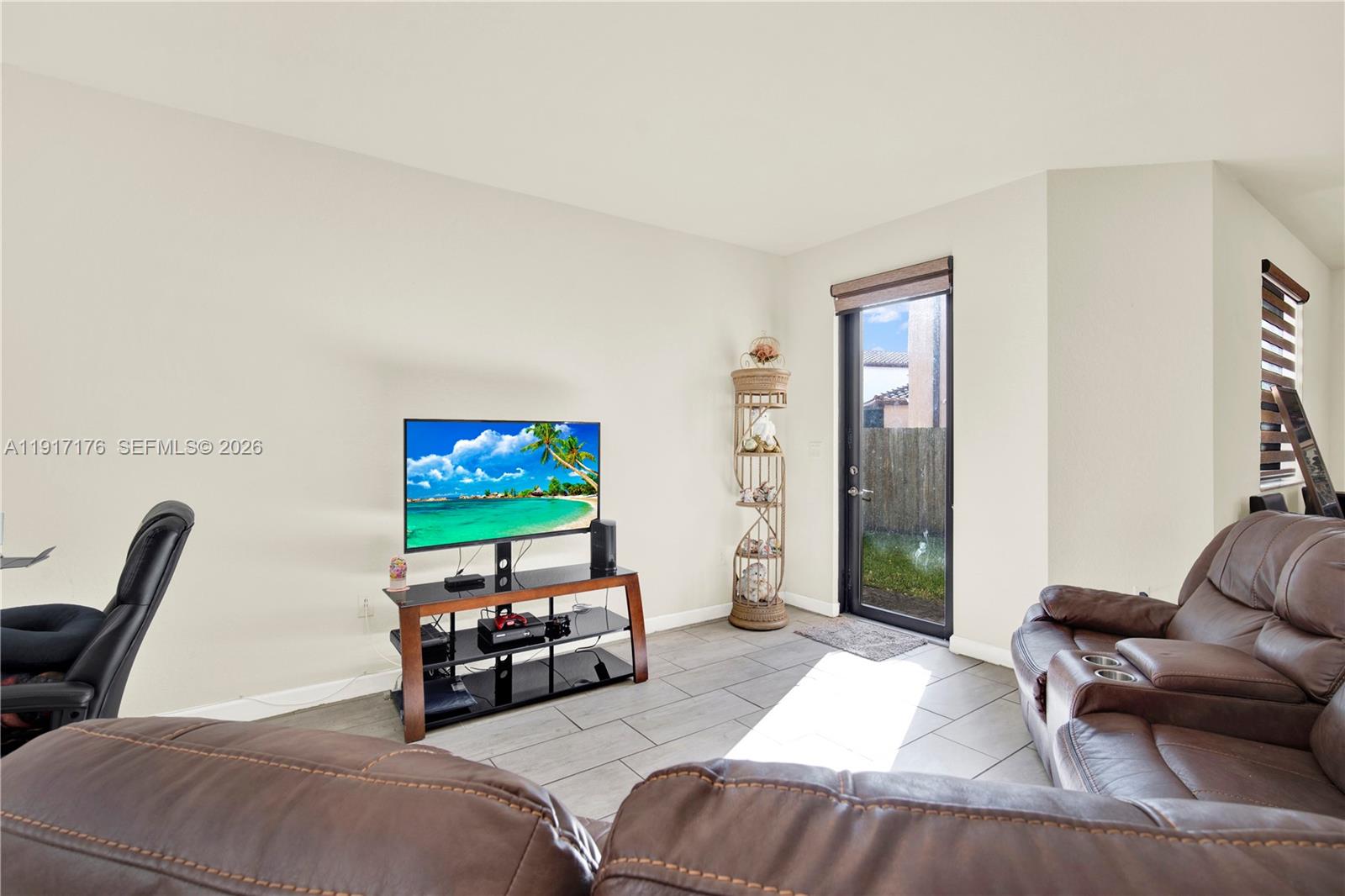 217 Northeast 23rd Terrace Homestead, FL 33033 - Photo 15 of 59 a bedroom with furniture and a flat screen tv