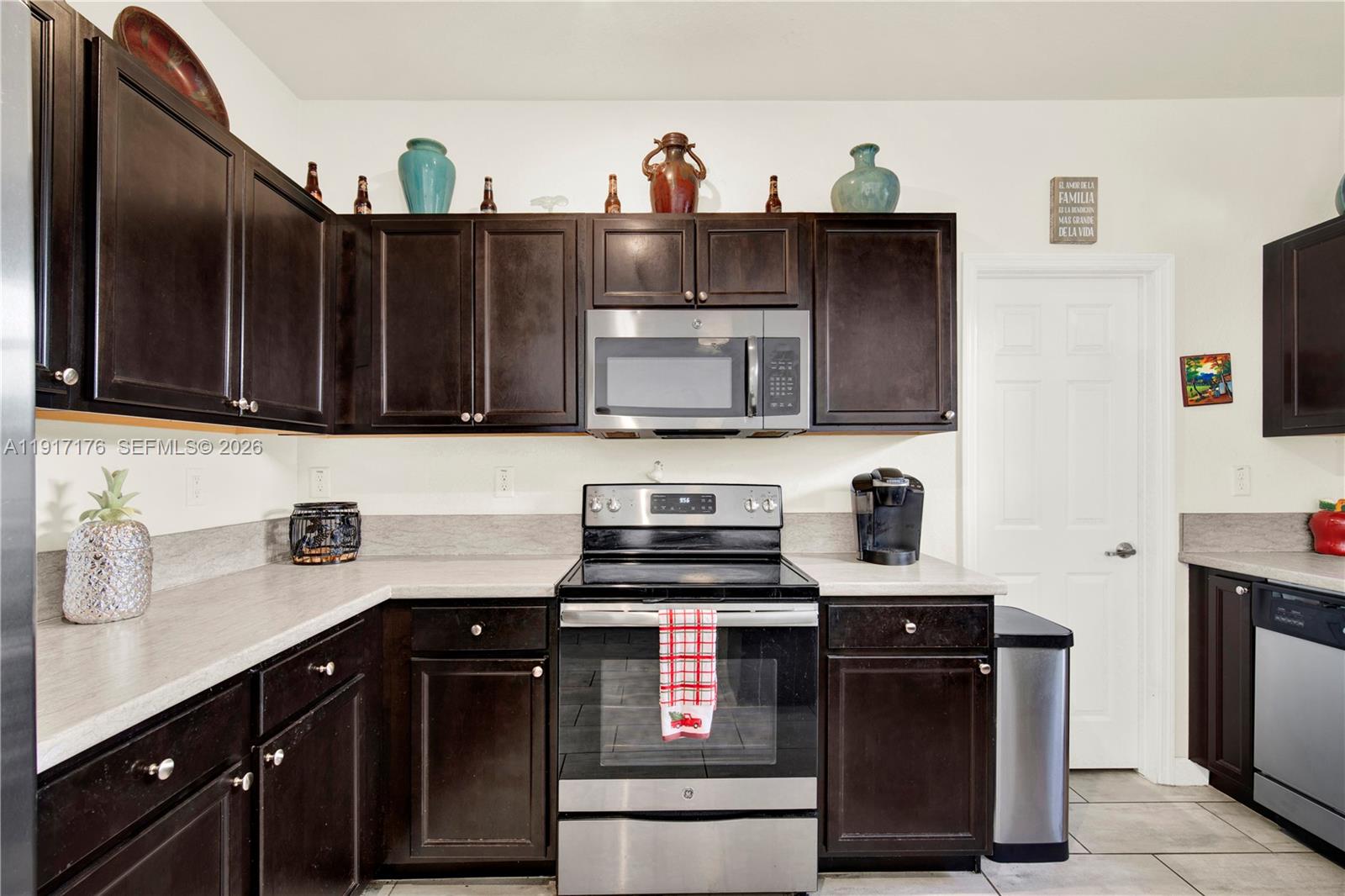217 Northeast 23rd Terrace Homestead, FL 33033 - Photo 18 of 59 a kitchen with stainless steel appliances a stove and a microwave