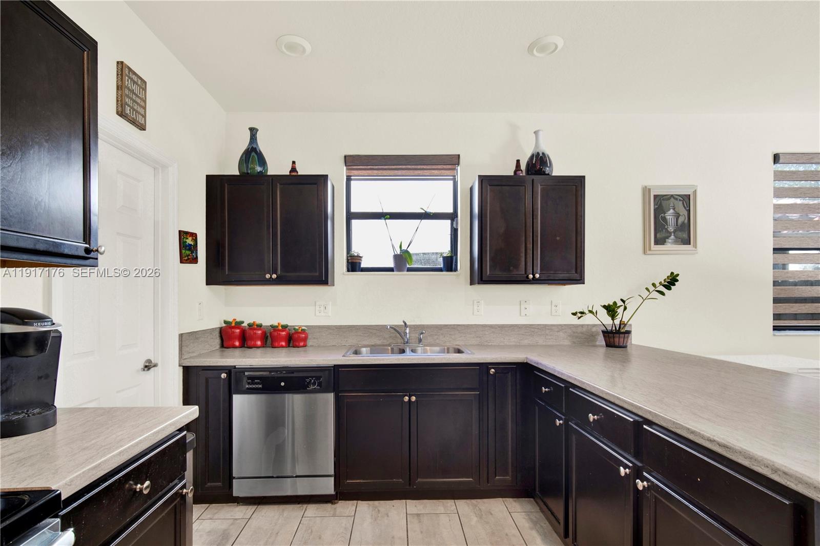 217 Northeast 23rd Terrace Homestead, FL 33033 - Photo 19 of 59 a kitchen with a sink and cabinets