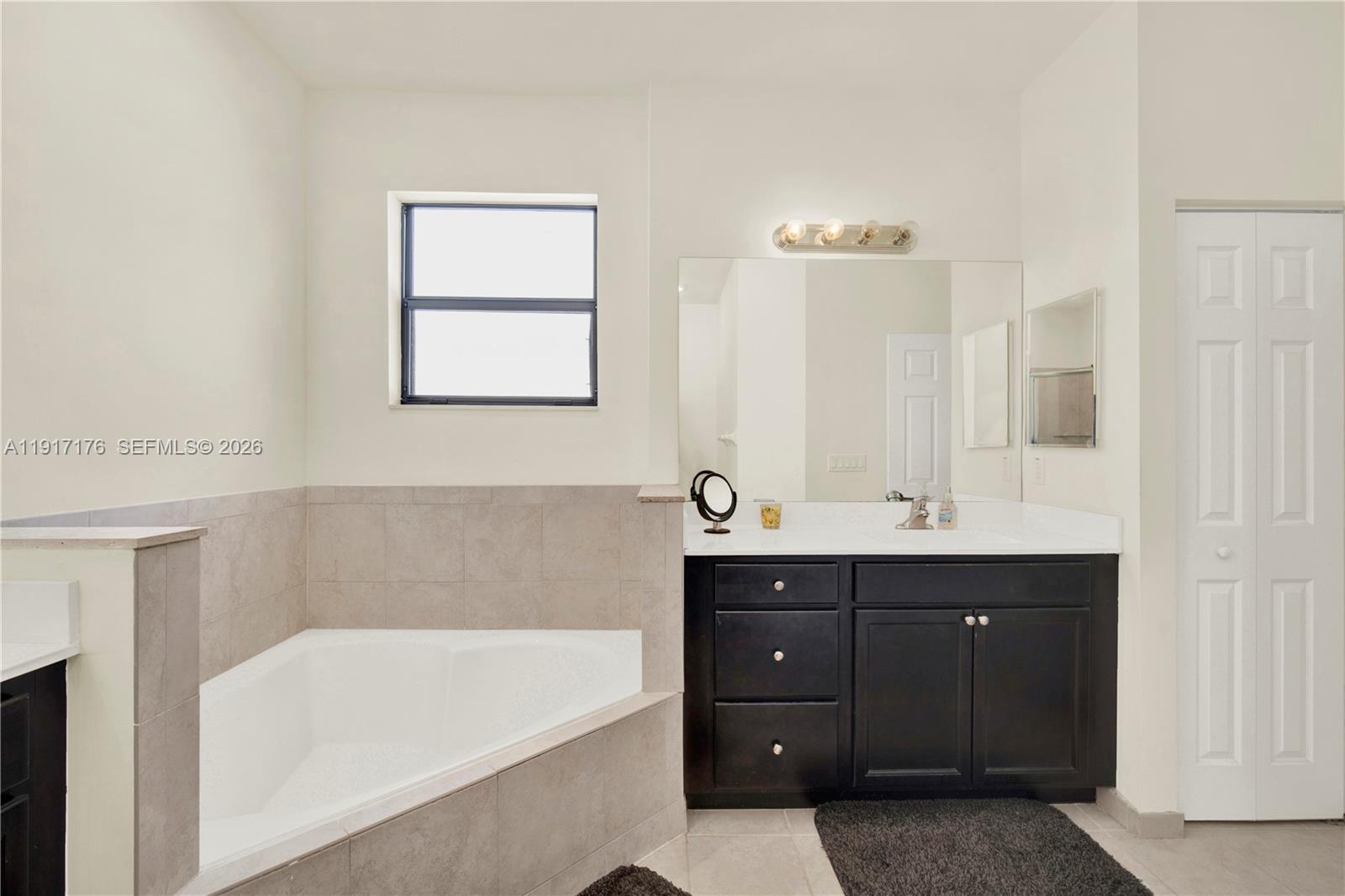 217 Northeast 23rd Terrace Homestead, FL 33033 - Photo 25 of 59 a bathroom with a tub sink and mirror