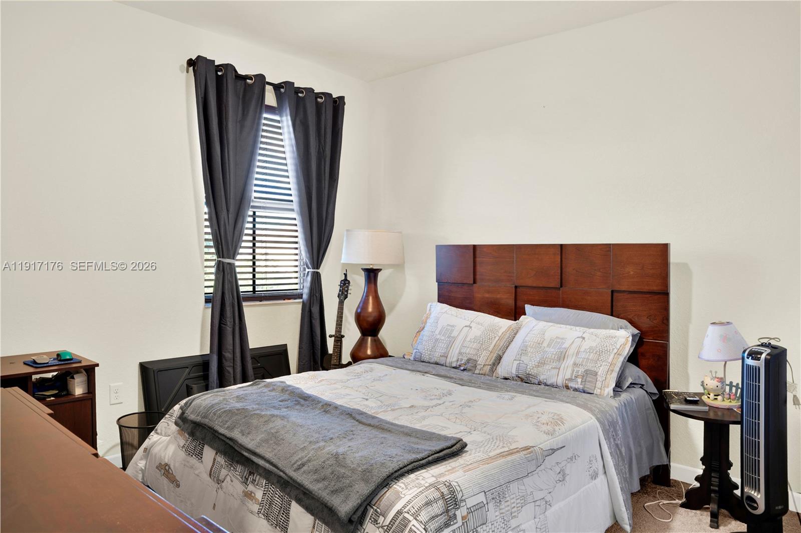 217 Northeast 23rd Terrace Homestead, FL 33033 - Photo 27 of 59 a bedroom with a bed and wooden floor