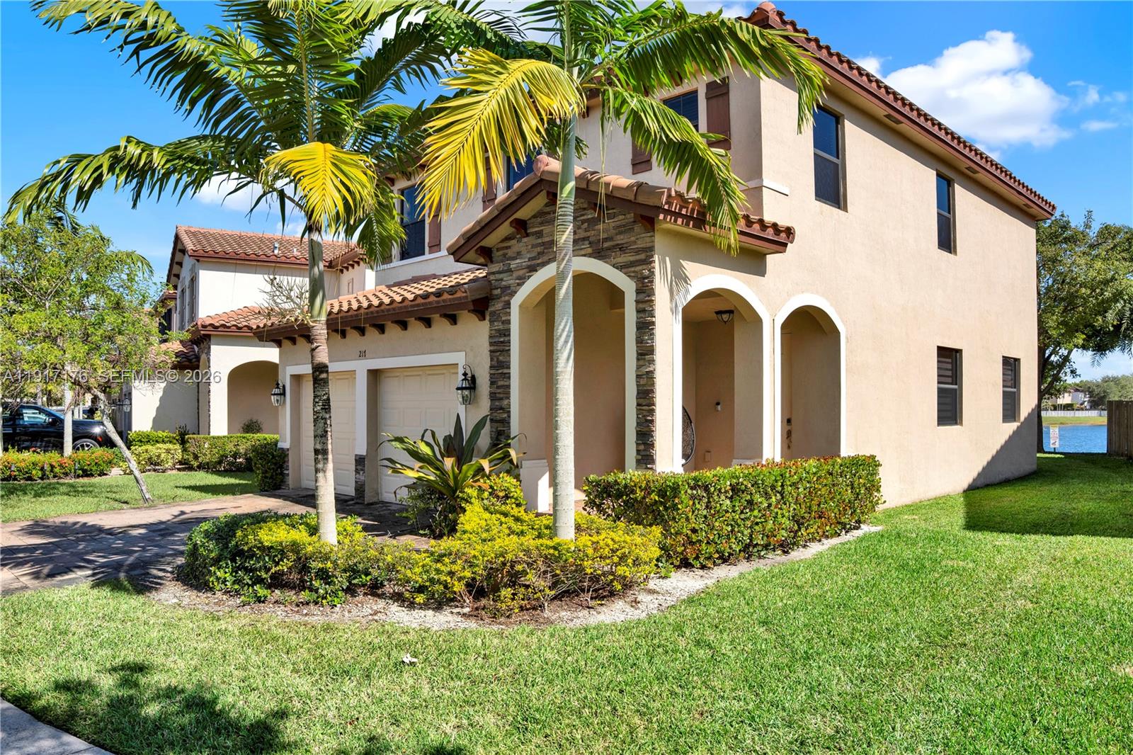 217 Northeast 23rd Terrace Homestead, FL 33033 - Photo 3 of 59 a view of a white house with a big yard and potted plants