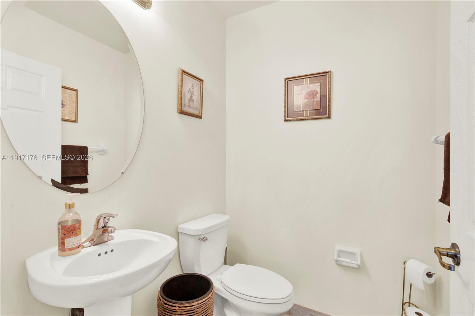 217 Northeast 23rd Terrace Homestead, FL 33033 - Photo 32 of 59 a bathroom with a toilet sink and a mirror