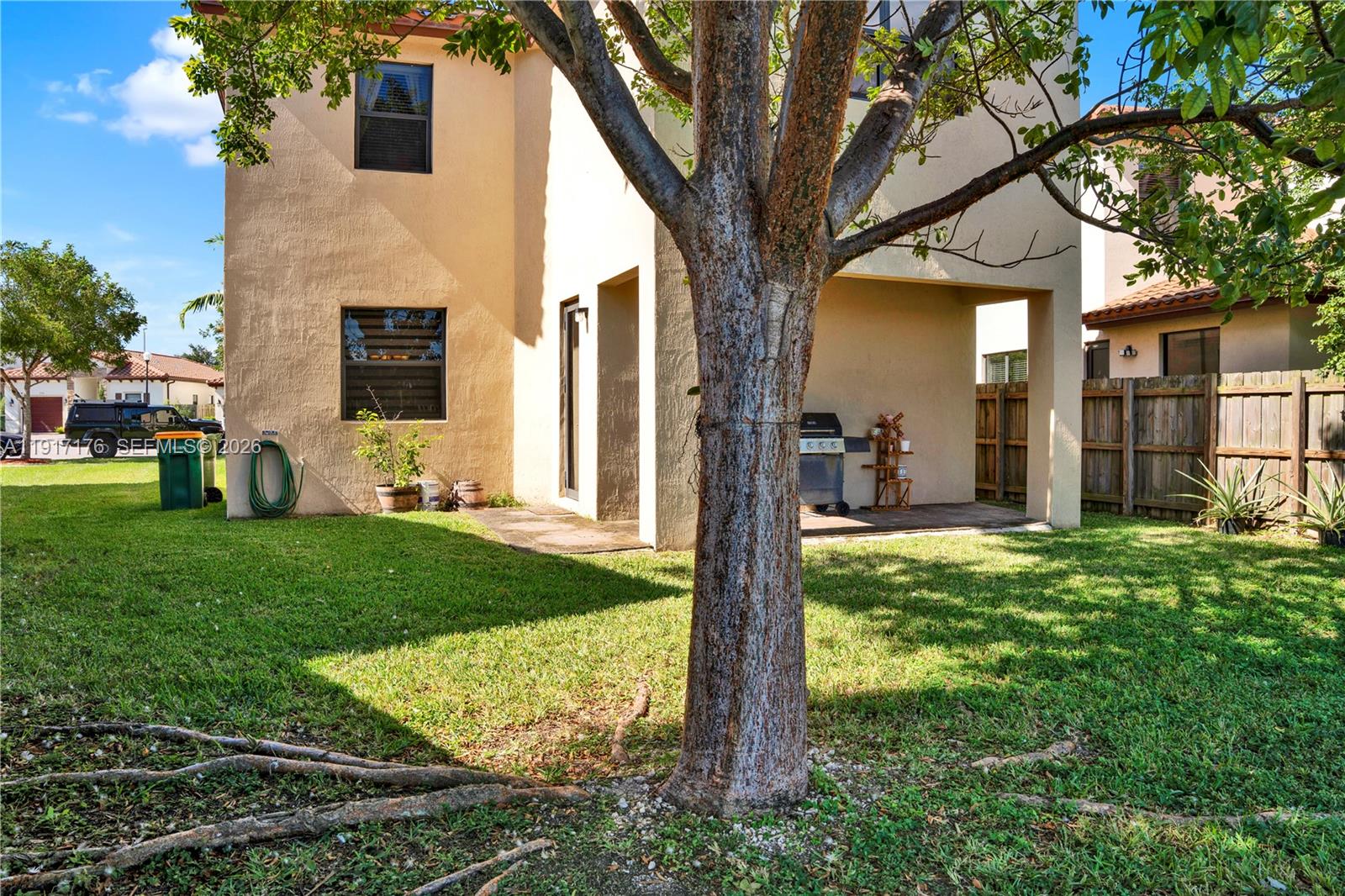 217 Northeast 23rd Terrace Homestead, FL 33033 - Photo 36 of 59 a tree in front of a white house