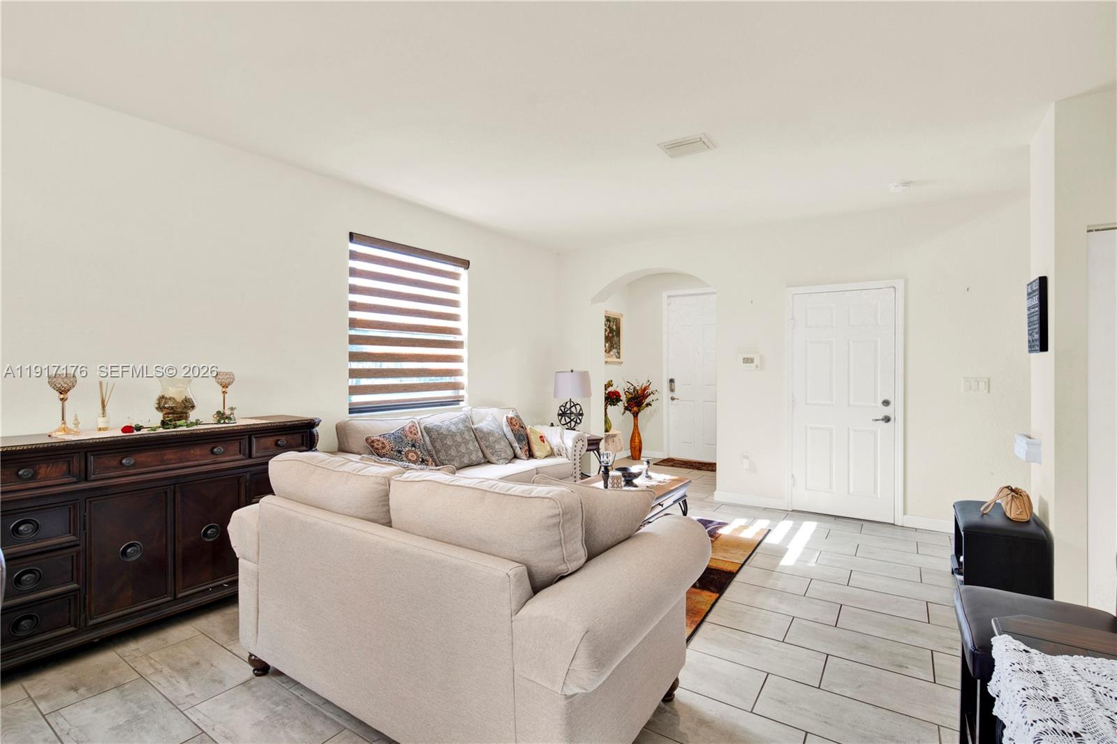 217 Northeast 23rd Terrace Homestead, FL 33033 - Photo 10 of 59 a living room with furniture and a lamp