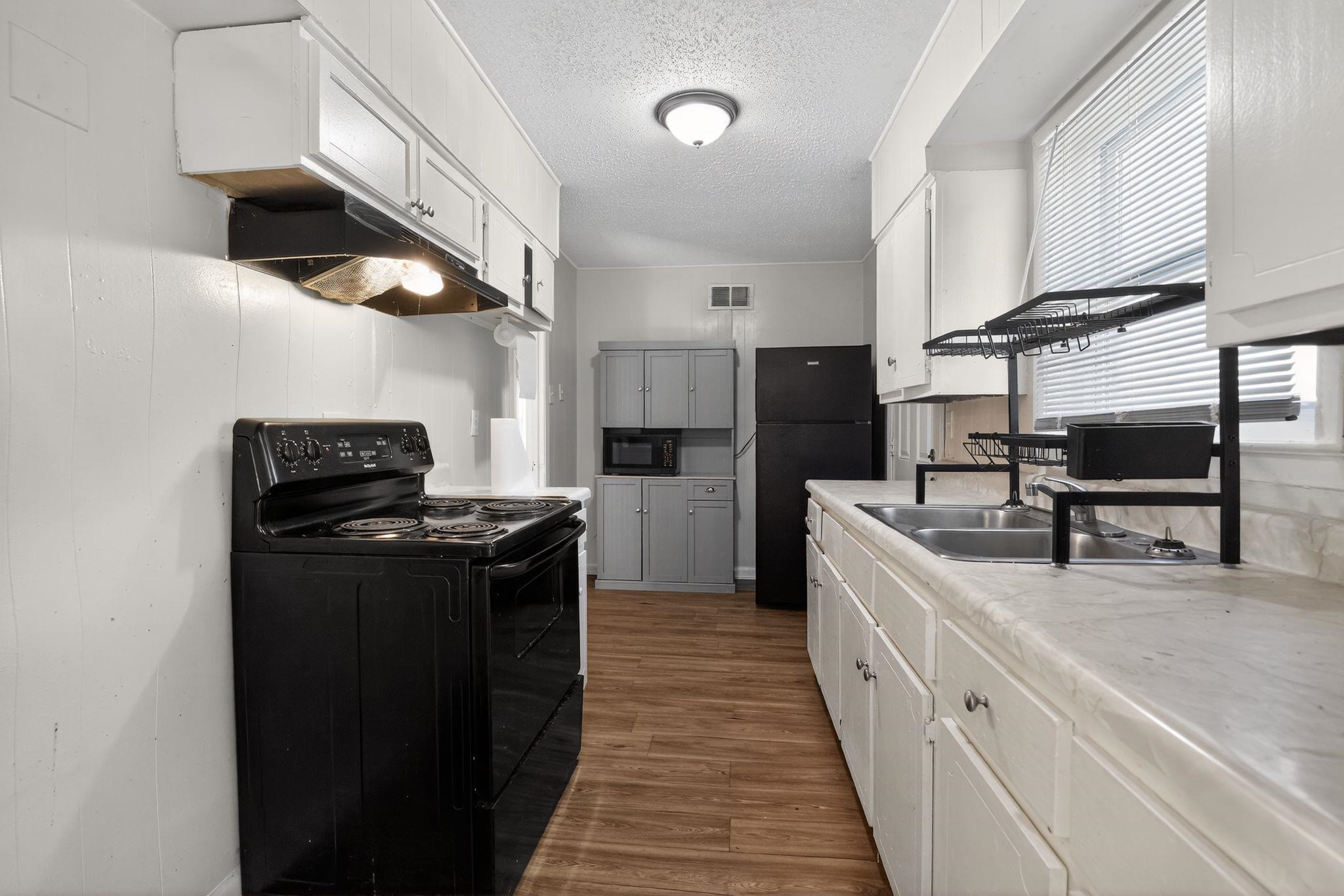 2144 St Elmo Avenue Memphis, TN 38127 - Photo 13 of 31 a kitchen with stainless steel appliances granite countertop a stove and a sink