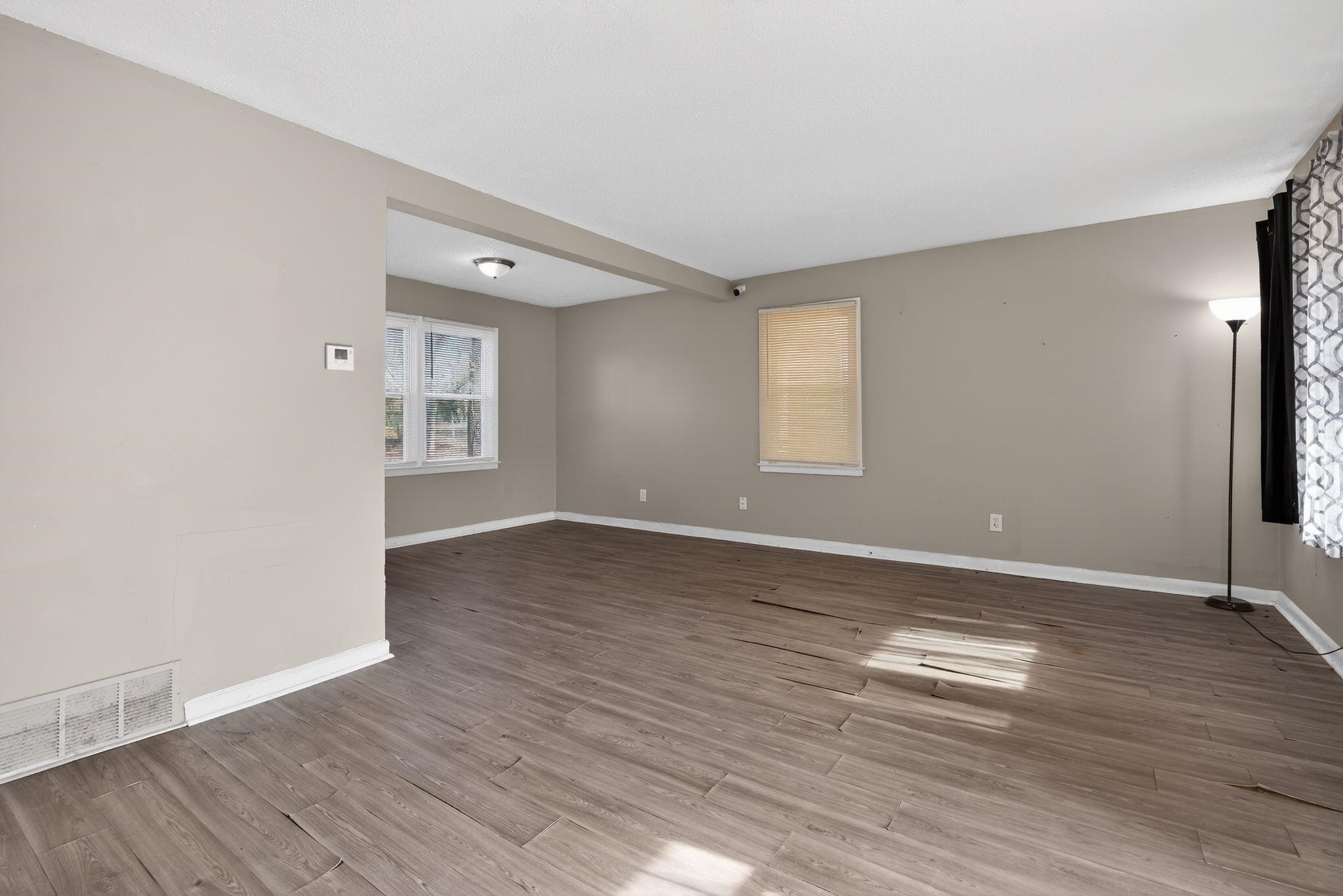 2144 St Elmo Avenue Memphis, TN 38127 - Photo 5 of 31 an empty room with wooden floor and windows