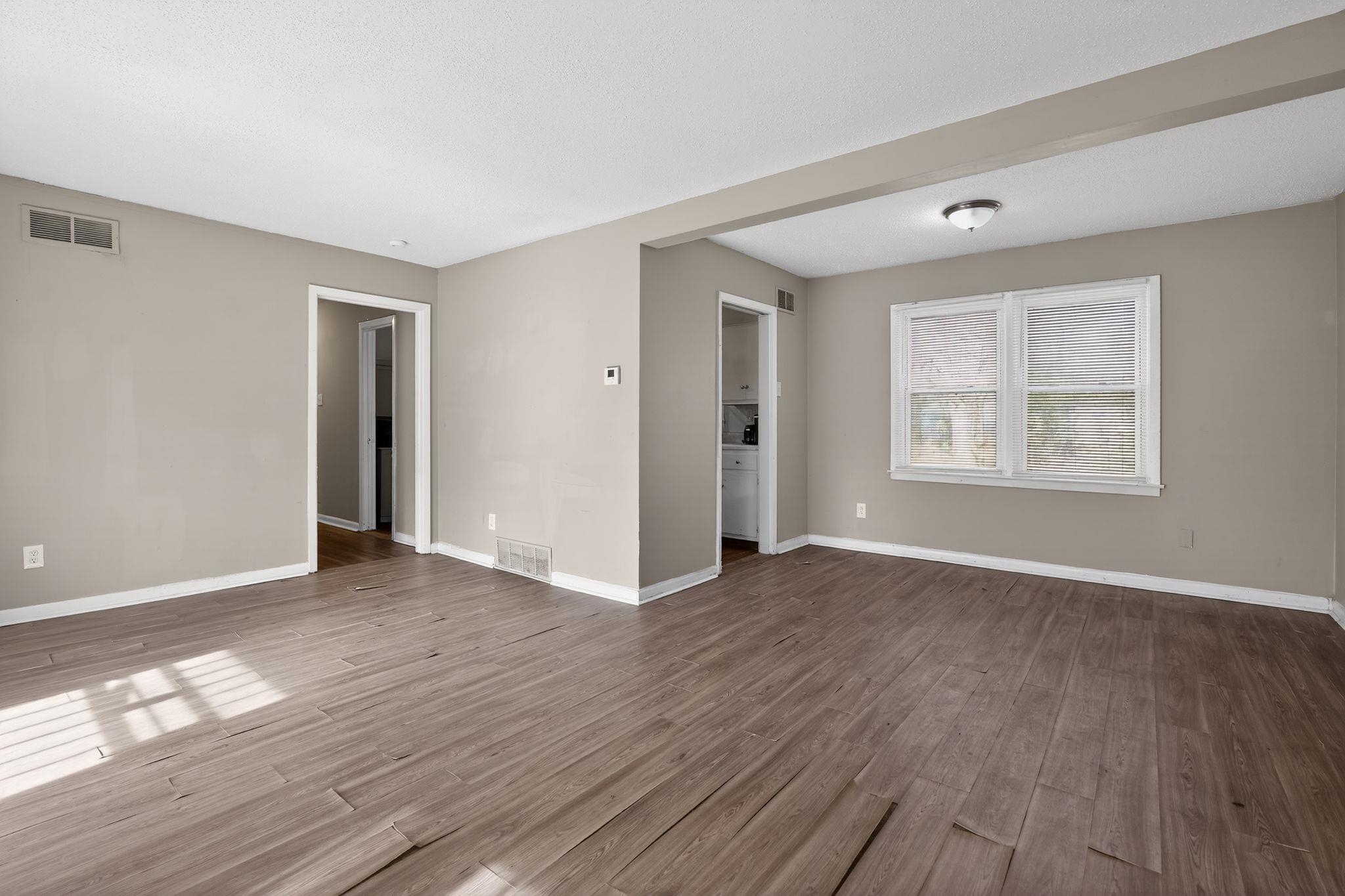 2144 St Elmo Avenue Memphis, TN 38127 - Photo 9 of 31 an empty room with wooden floor and windows