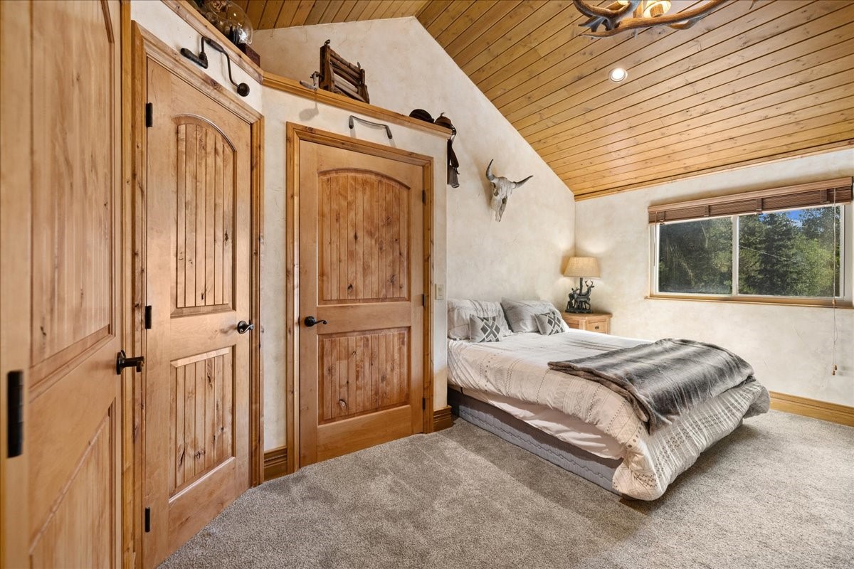19 East Hanson Road Keystone, CO 80435 - Photo 11 of 24 Carpeted bedroom featuring vaulted ceiling and wooden ceiling