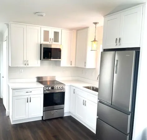 a kitchen with stainless steel appliances a stove microwave and a refrigerator