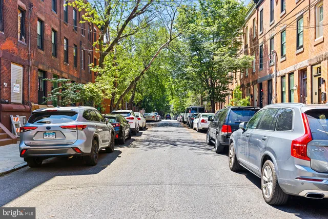 a view of a cars park in front of a building