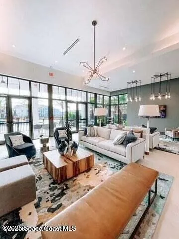 a living room with furniture large window and a table