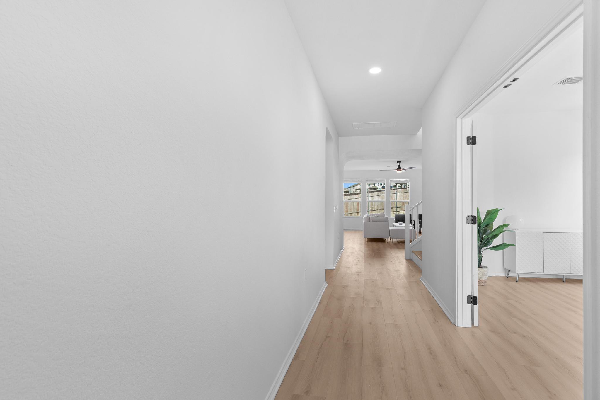 4712 Pear Light Rd Manor Manor, TX 78653 - Photo 14 of 39 Corridor featuring light wood-style floors, stairway, and recessed lighting