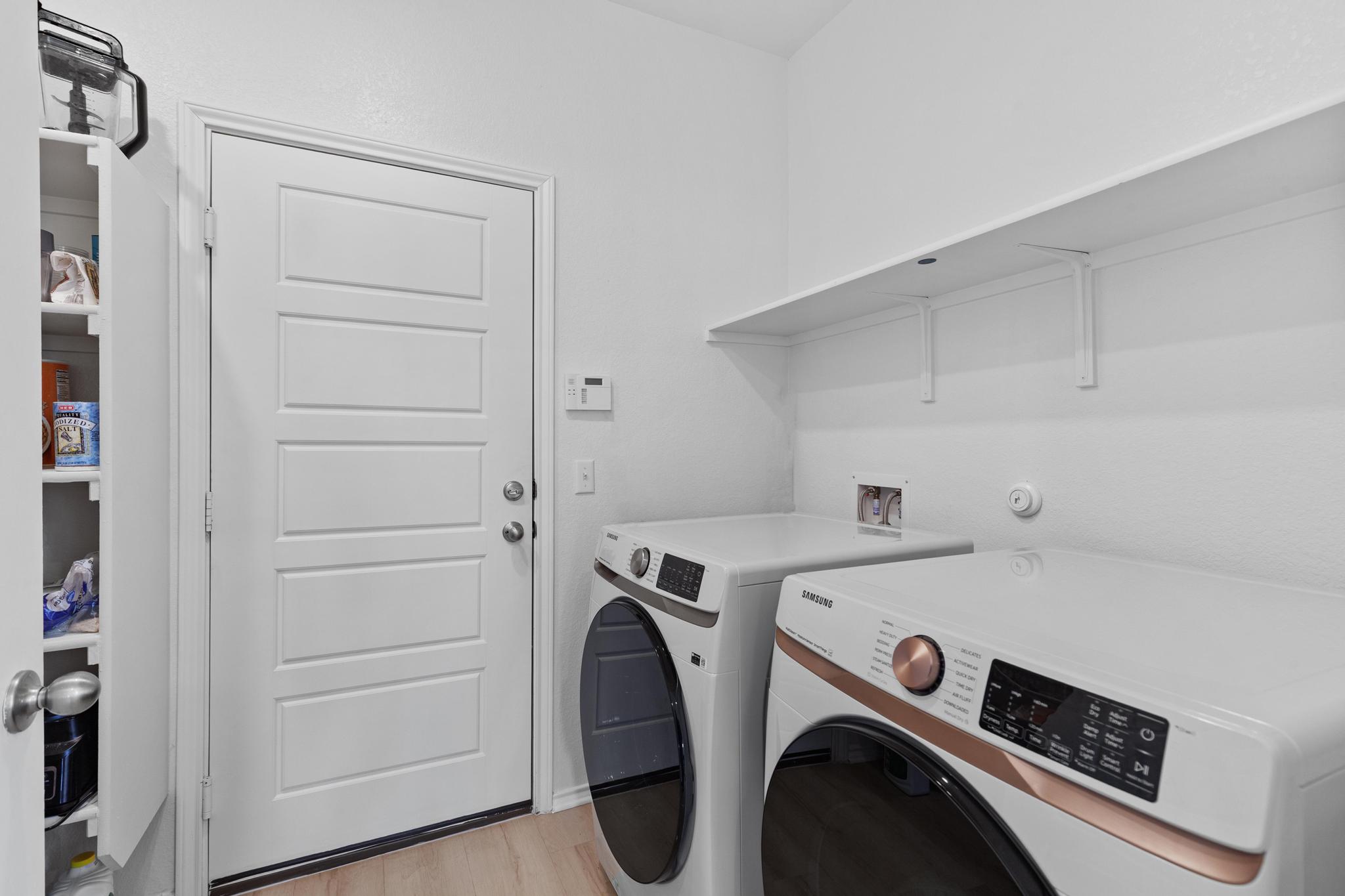 4712 Pear Light Rd Manor Manor, TX 78653 - Photo 17 of 39 Washroom with light wood-style flooring and washing machine and dryer