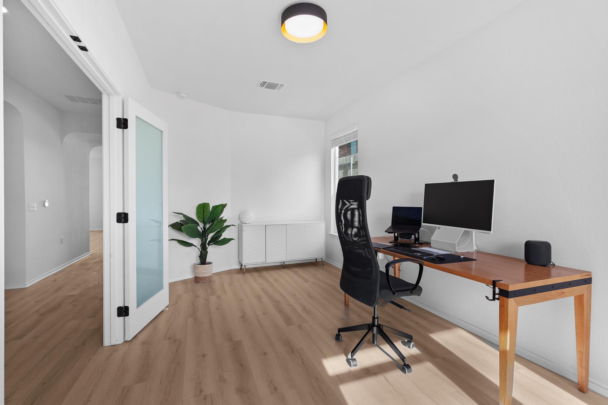 4712 Pear Light Rd Manor Manor, TX 78653 - Photo 20 of 39 Home office with arched walkways and light wood-style floors