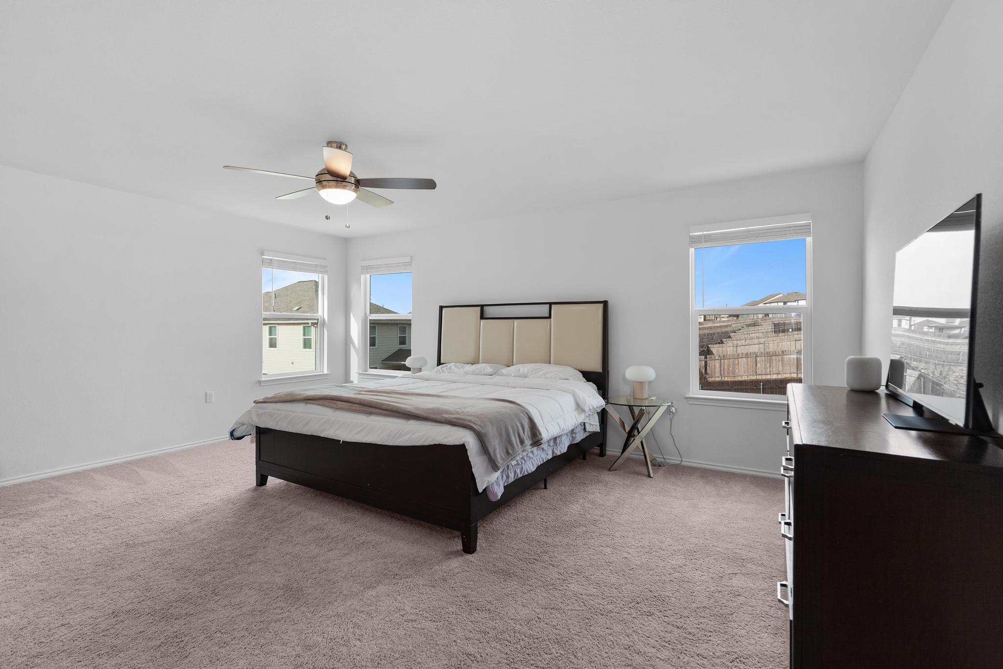 4712 Pear Light Rd Manor Manor, TX 78653 - Photo 30 of 39 Bedroom with light carpet and ceiling fan