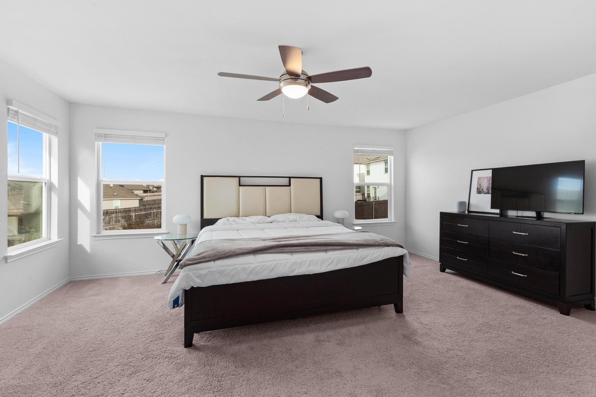 4712 Pear Light Rd Manor Manor, TX 78653 - Photo 31 of 39 Bedroom with light carpet and a ceiling fan