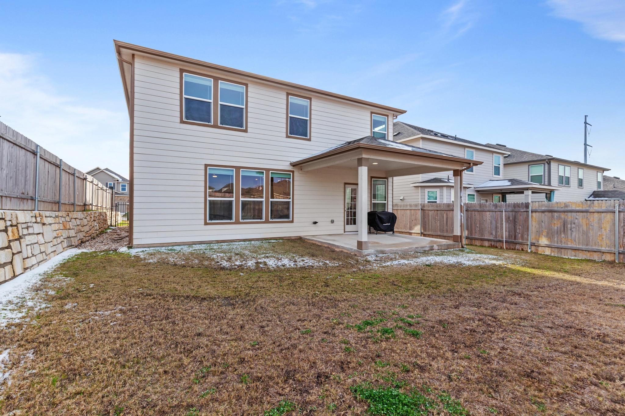 4712 Pear Light Rd Manor Manor, TX 78653 - Photo 36 of 39 Rear view of house with a fenced backyard and a patio