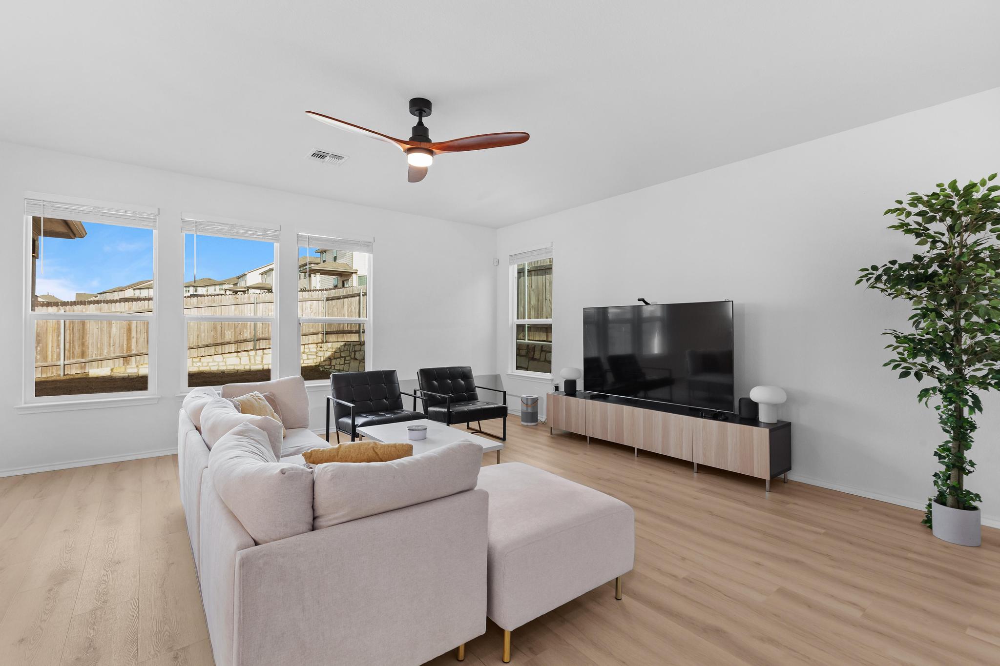4712 Pear Light Rd Manor Manor, TX 78653 - Photo 4 of 39 Living area with light wood-style flooring and a ceiling fan