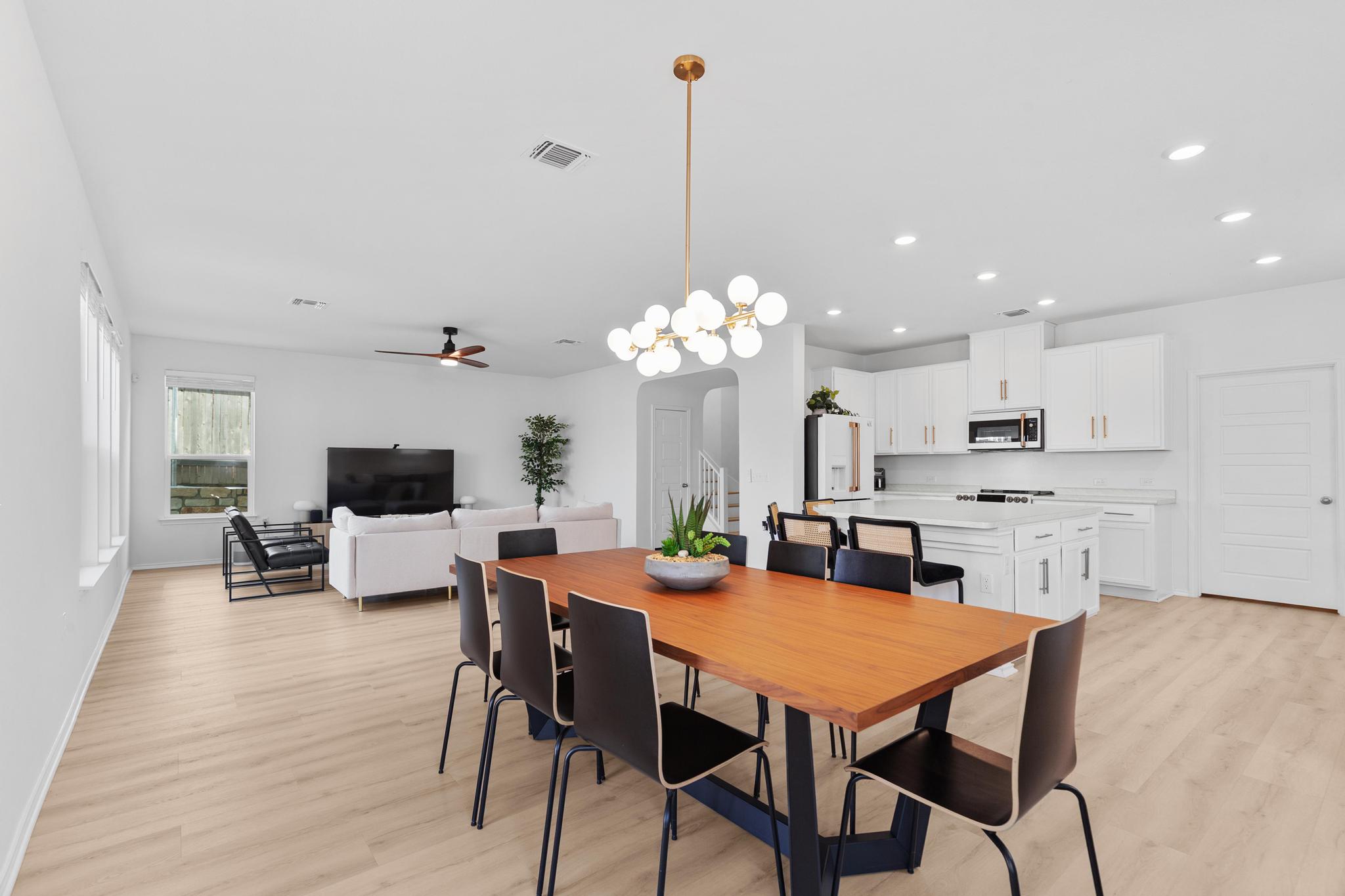 4712 Pear Light Rd Manor Manor, TX 78653 - Photo 10 of 39 Dining room featuring a chandelier, light wood-type flooring, a ceiling fan, and recessed lighting