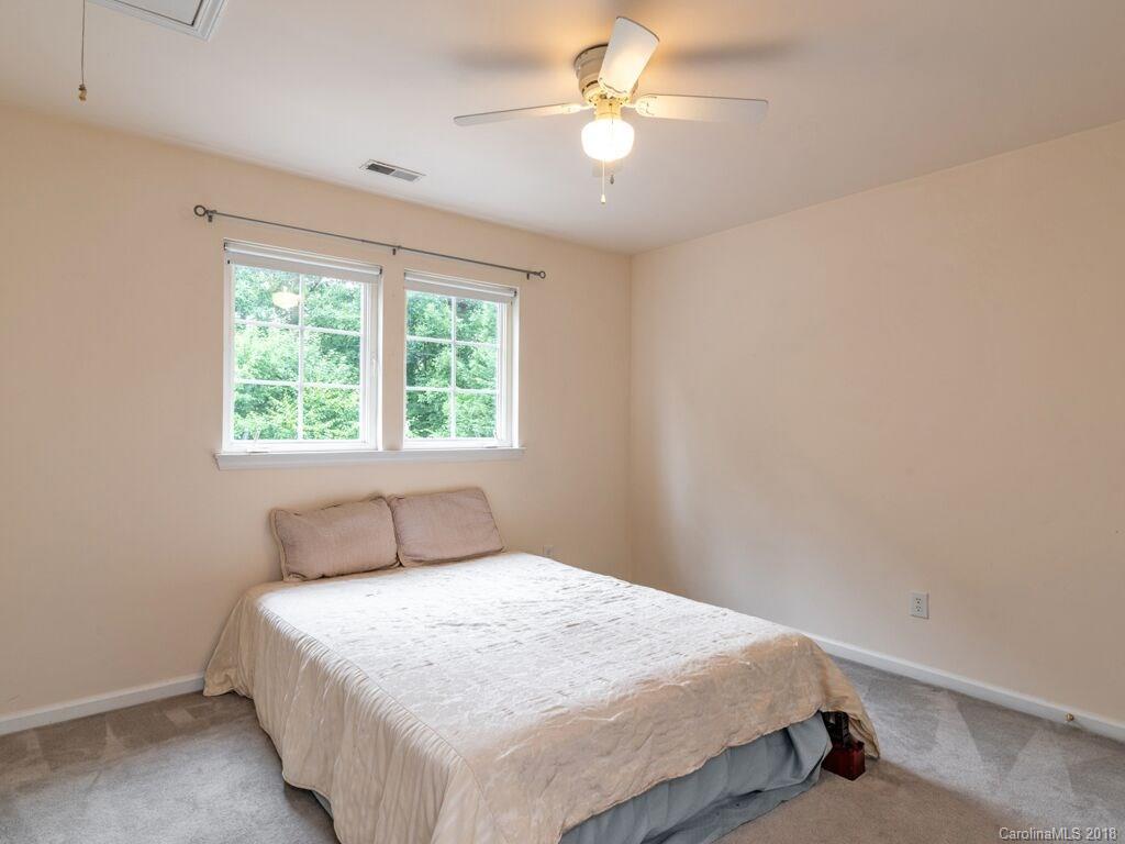 253 Hyde Park Lane Fort Mill, SC 29708 - Photo 19 of 26 a bedroom with a bed and a chandelier