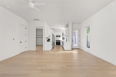 a kitchen with white cabinets and white appliances