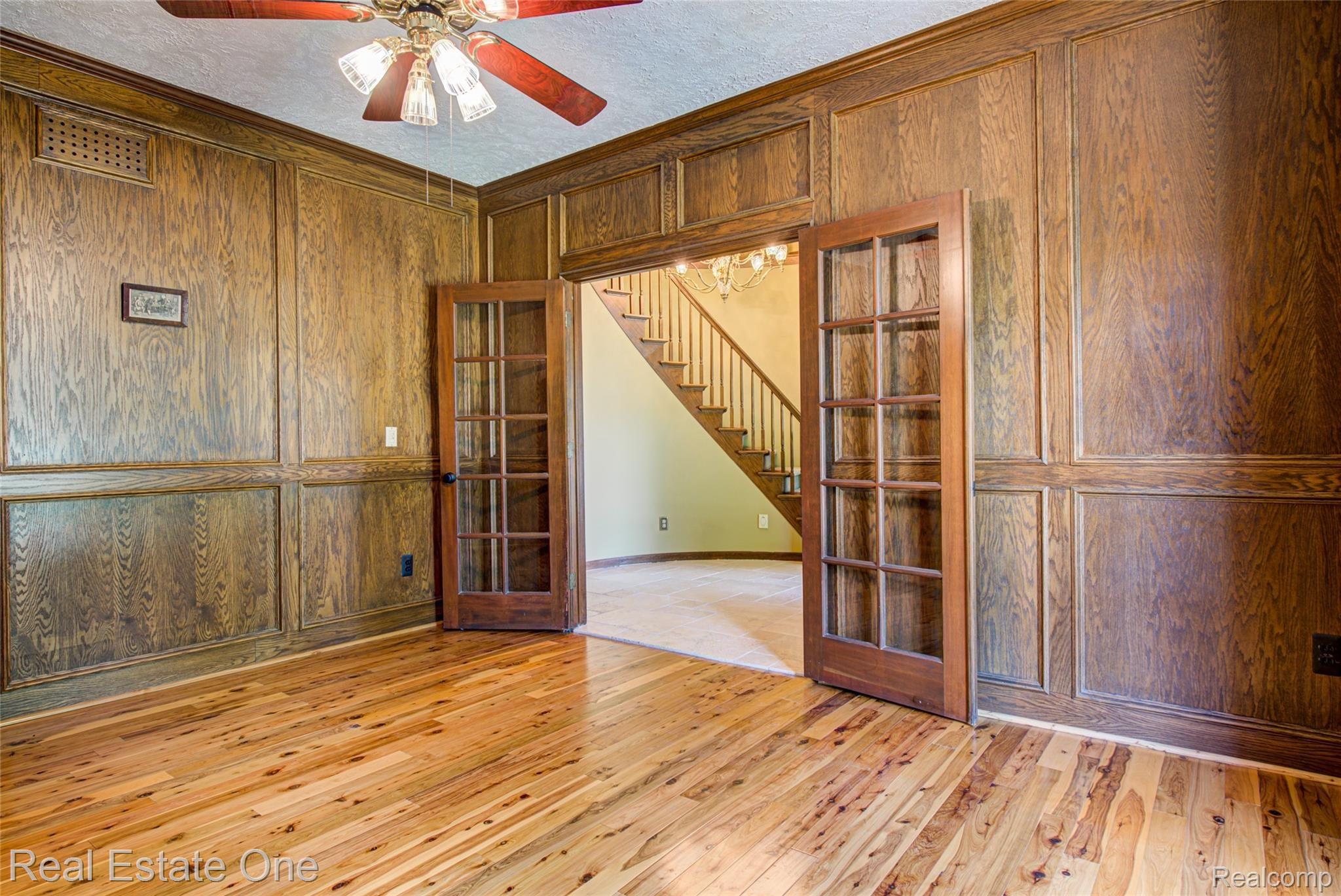 3274 Quail Ridge Circle Rochester, MI 48309 - Photo 14 of 74 Wood paneled library with double French glass doors and Australian cypress floors