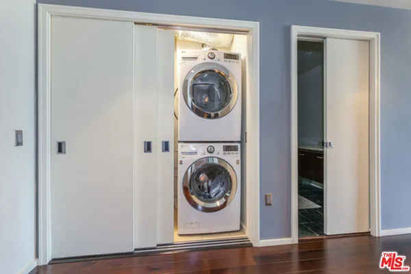 a view of a storage and utility room with washer and dryer