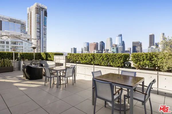 a view of a patio with a table and chairs