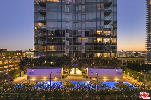 a view of a swimming pool with outdoor seating