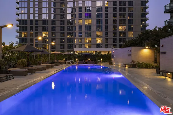 a view of a pool with a outdoor seating