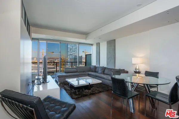 a living room with furniture kitchen view and a table