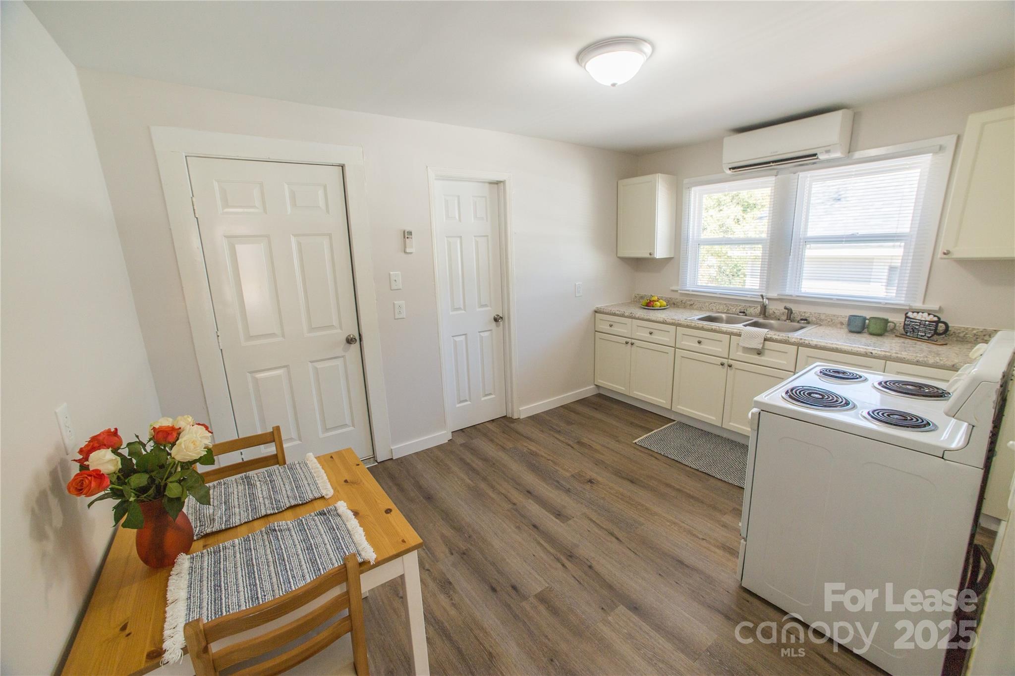 654 Wilson Street Kannapolis, NC 28083 - Photo 3 of 15 a kitchen with wooden floor and electronic appliances