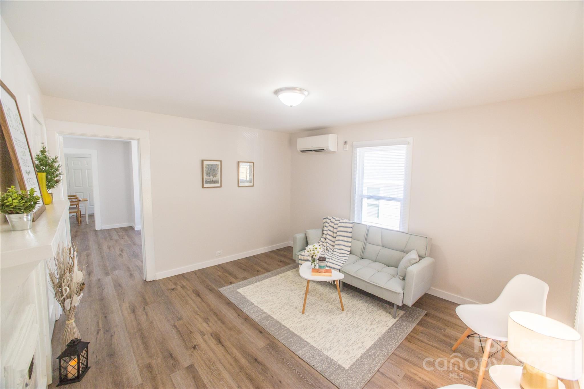 654 Wilson Street Kannapolis, NC 28083 - Photo 4 of 15 a living room with furniture and a wooden floor