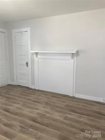 a view of a room with wooden floor