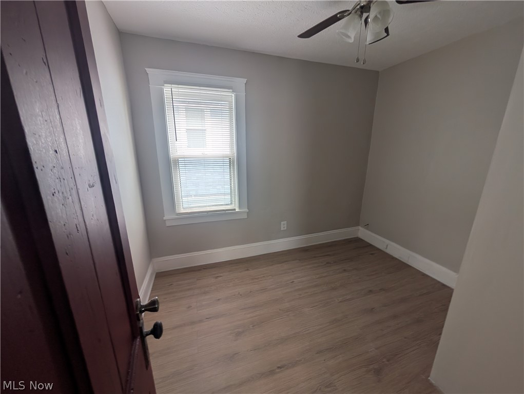 7515 Ottawa Road Cleveland, OH 44105 - Photo 13 of 21 Neutral tone painted walls with white trim and wood-finish flooring