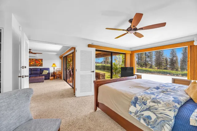 a bed room with a bed and a large window