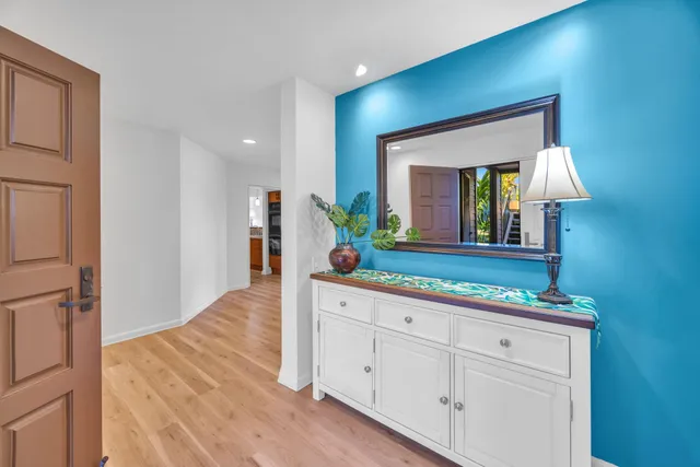 a spacious bathroom with a granite countertop sink and a mirror