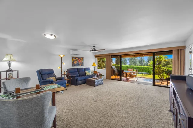 a living room with furniture and large windows