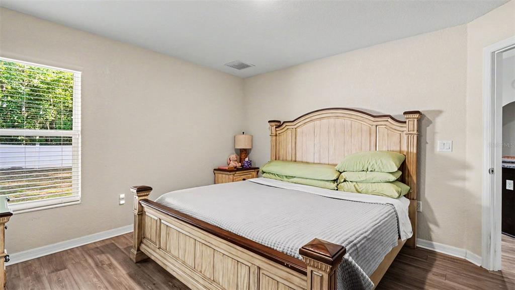 6201 East Peach Street Inverness, FL 34452 - Photo 12 of 30 a bed sitting in a bedroom next to a window