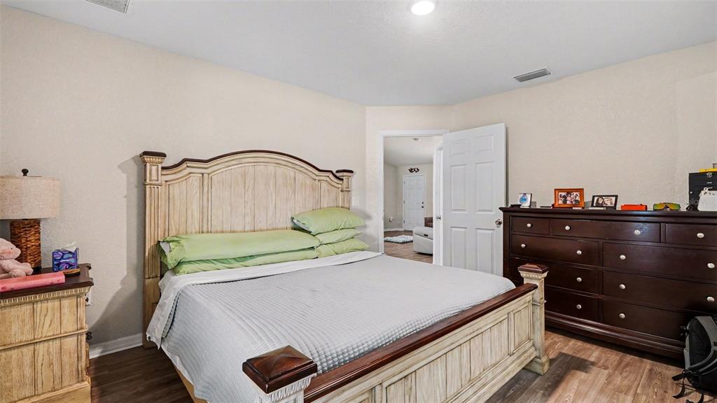 6201 East Peach Street Inverness, FL 34452 - Photo 14 of 30 a bedroom with a bed and a dresser