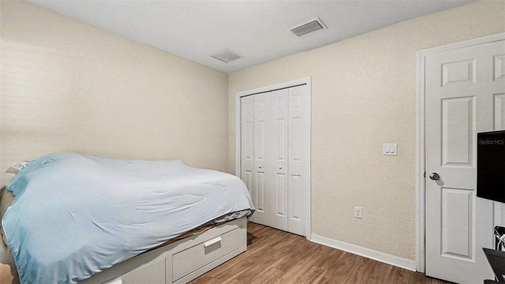 6201 East Peach Street Inverness, FL 34452 - Photo 15 of 30 a room with a bed and wooden floor