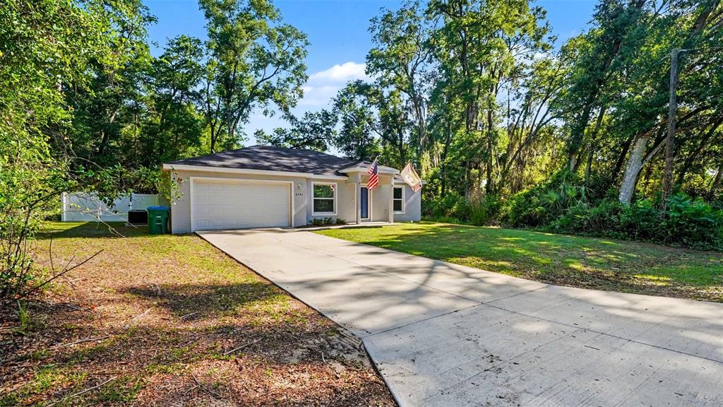6201 East Peach Street Inverness, FL 34452 - Photo 2 of 30 a view of a house with backyard and trees