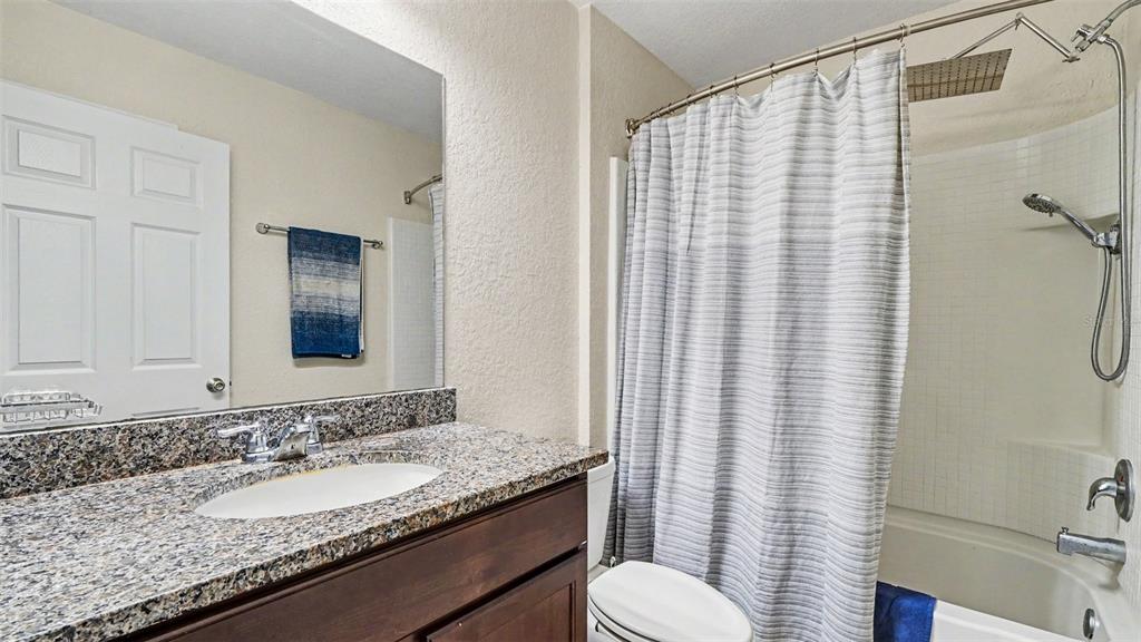 6201 East Peach Street Inverness, FL 34452 - Photo 22 of 30 a bathroom with a granite countertop sink and a mirror