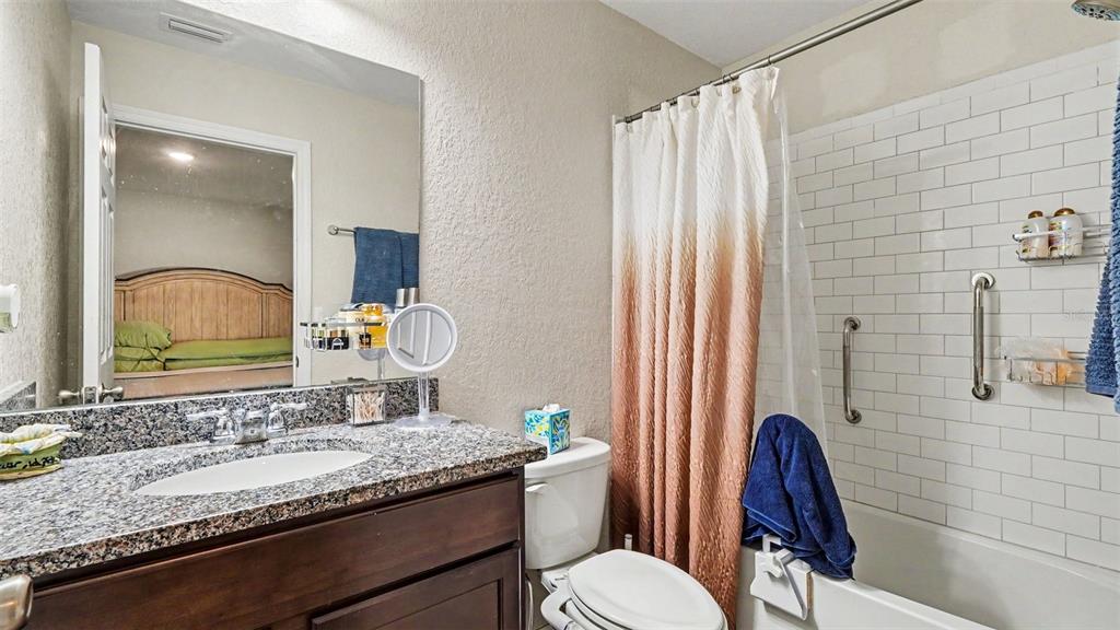 6201 East Peach Street Inverness, FL 34452 - Photo 23 of 30 a bathroom with a granite countertop sink vanity mirror and toilet