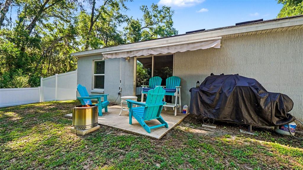 6201 East Peach Street Inverness, FL 34452 - Photo 28 of 30 a view of a chair and table in backyard