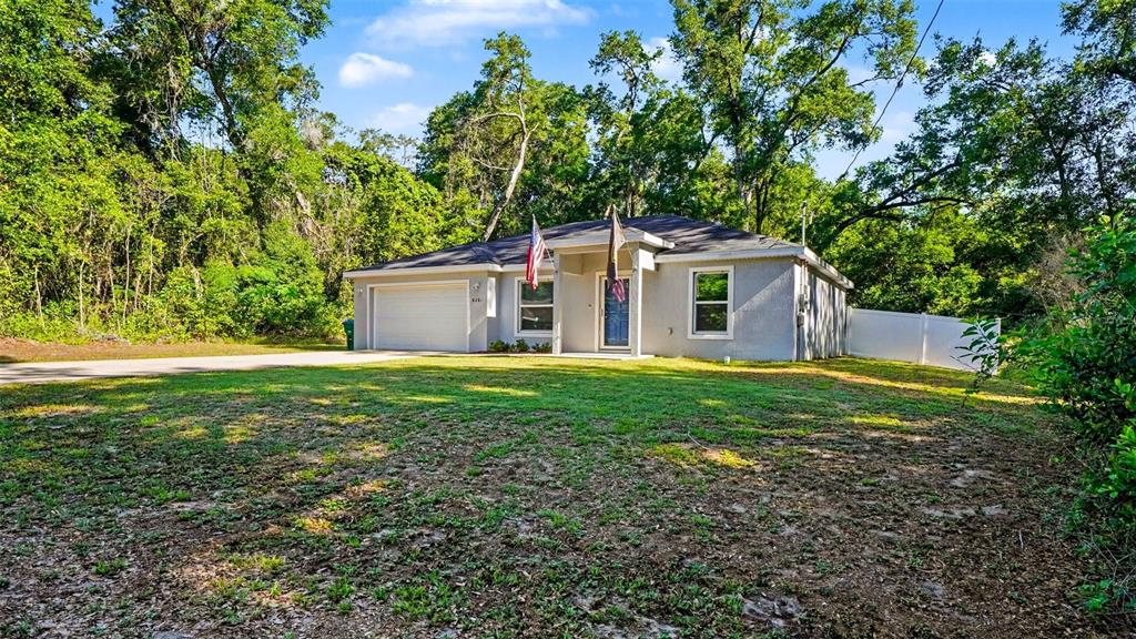6201 East Peach Street Inverness, FL 34452 - Photo 3 of 30 a view of a house with yard and a garden