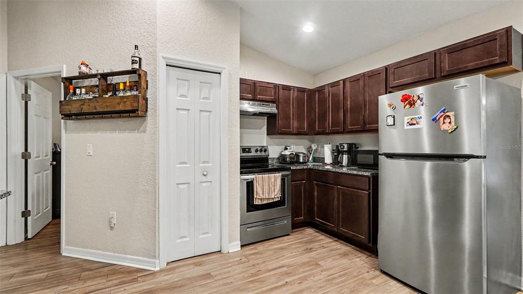 6201 East Peach Street Inverness, FL 34452 - Photo 10 of 30 a kitchen with stainless steel appliances granite countertop a refrigerator and a stove top oven