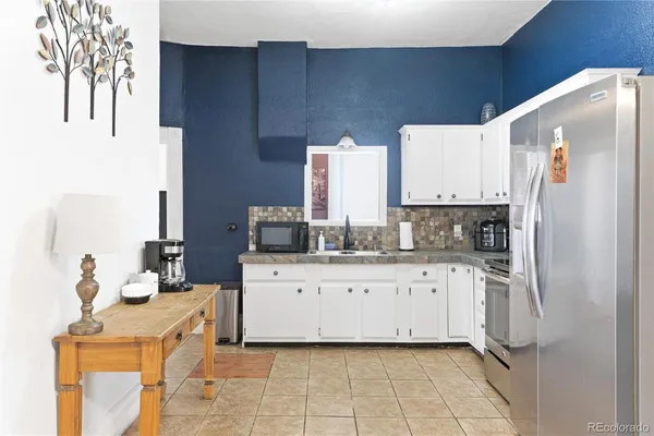 a kitchen with stainless steel appliances a refrigerator sink and cabinets
