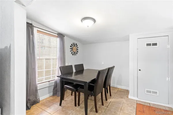 a view of a dining room with furniture and window